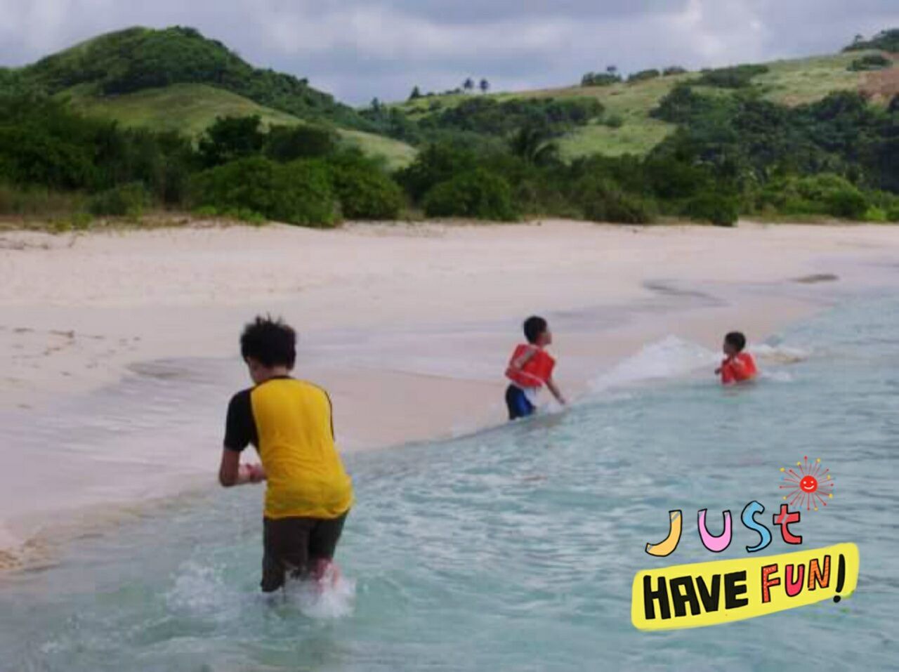 REAR VIEW OF PEOPLE ENJOYING AT BEACH