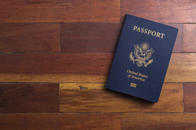 Close-up of passport on wooden table