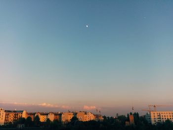 View of buildings against clear sky at dusk