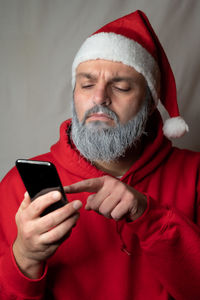 Midsection of man holding mobile phone