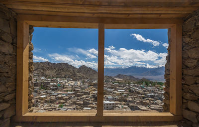 Panoramic view of buildings seen through window