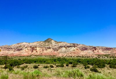 Scenic view of mountain against clear blue sky