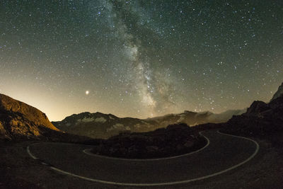 Scenic view of mountains against sky at night