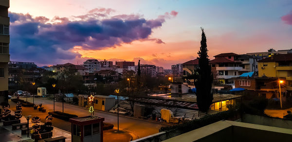 High angle view of illuminated buildings against sky at sunset