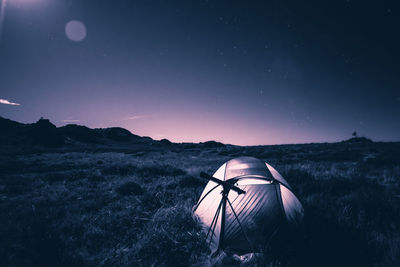 Illuminated tent on field at night