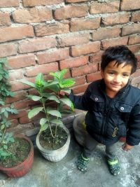 Portrait of boy against wall