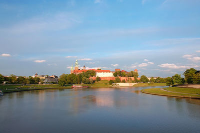 Panorama of royal wawel castle reflecting in the vistula river, krakow - poland