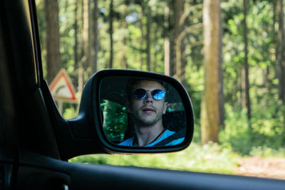 Reflection of man in car mirror