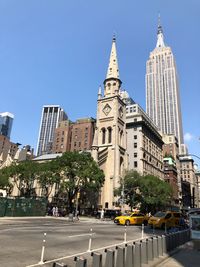 View of city buildings against clear sky