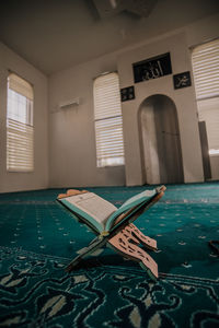 Empty chairs and table in building