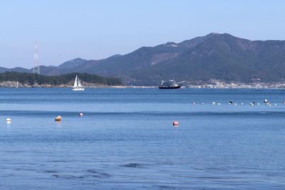 Sailboat on sea against clear sky