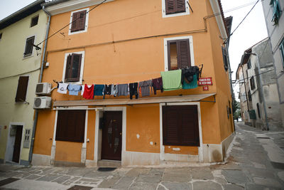 Clothesline hanging against wall in city