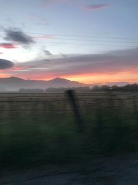 Scenic view of field against sky during sunset