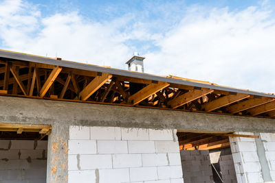 Roof trusses covered with a membrane on a detached house under construction, visible roof elements