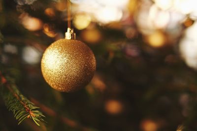 Close-up of hanging golden shiny christmas bauble