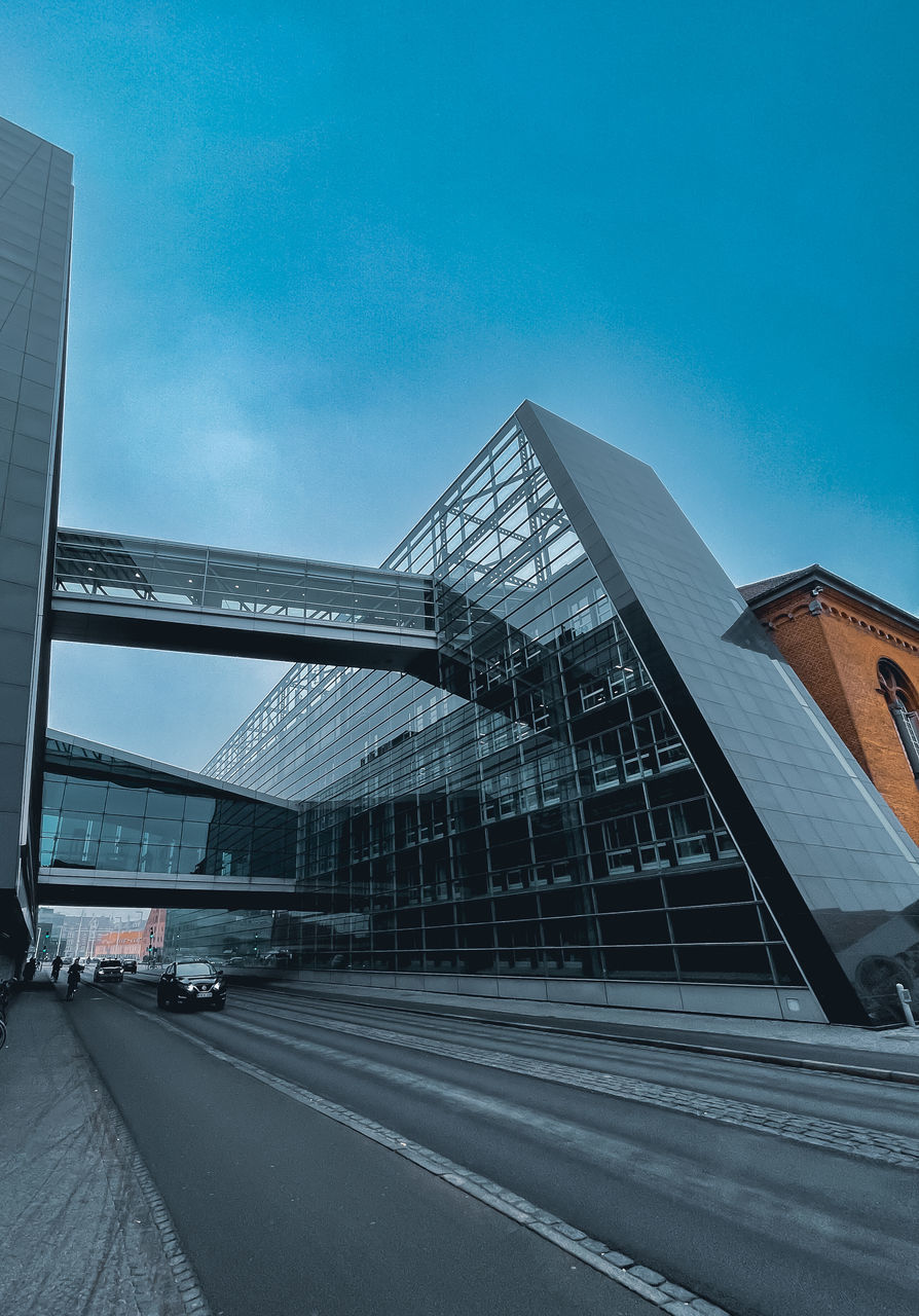 architecture, built structure, city, building exterior, sky, transportation, road, building, office building exterior, nature, street, skyscraper, no people, city life, blue, travel, travel destinations, landmark, facade, outdoors, bridge, cityscape, stadium, business, day, mode of transportation, convention center, cloud, office, business finance and industry, glass, motor vehicle, city street