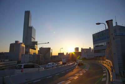 Cityscape against clear sky during sunset