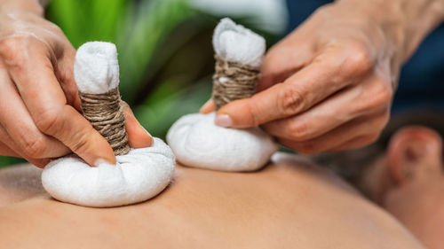 Ayurvedic massage with kizhi or herbal bags made from various dried herbs wrapped in cotton 