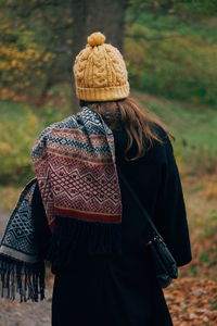 Rear view of woman standing in park during winter