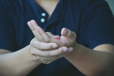Close-up of man holding hands