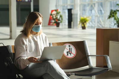 Young woman using laptop at home