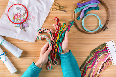 Directly above view of intertwined multi colored wool on table