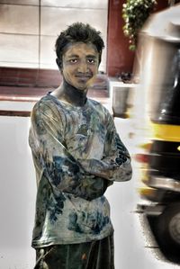 Portrait of man standing in city