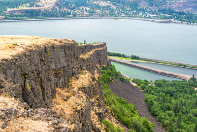 High angle view of river by cliff against sky