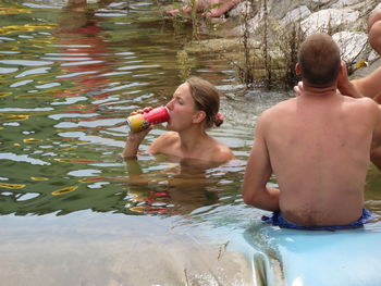 Rear view of shirtless man in swimming pool