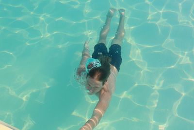 High angle view of young man swimming in pool