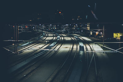 High angle view of illuminated railroad tracks at night