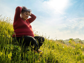 Senior lady meditating in nature