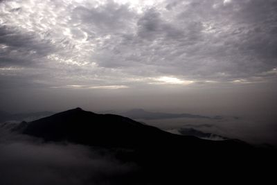 Scenic view of silhouette mountains against sky at sunset