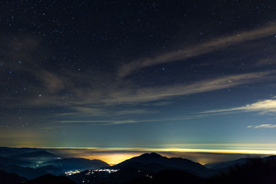 Scenic view of silhouette mountains against sky at night