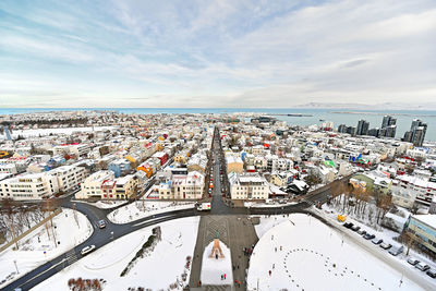High angle view of city by buildings against sky
