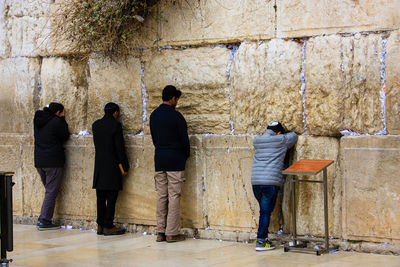 Rear view of people standing outdoors