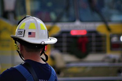 Rear view of man wearing hardhat outdoors