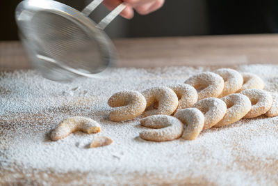 Midsection of person preparing cookies