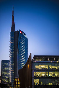 Low angle view of illuminated buildings against clear sky