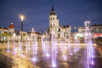 Fountain in city at night