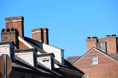 Low angle view of buildings against clear blue sky