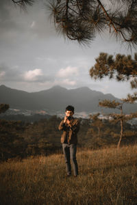 Man photographing while standing on land