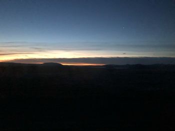 Scenic view of silhouette mountain against sky during sunset