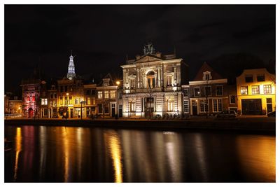 Haarlem. reflection of illuminated buildings in water at night. 