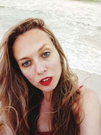 Close-up portrait of young woman at beach