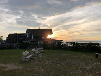 Built structure on field against sky during sunset