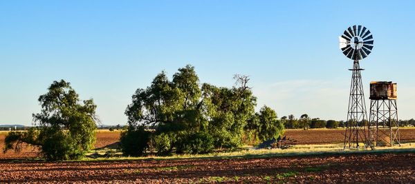 Windmill and water tower in fields