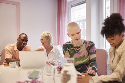 Coworkers sitting at business meeting in meeting room