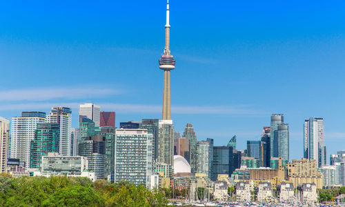 Buildings in city against blue sky