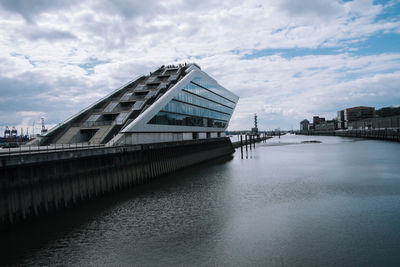 View of bridge over river against cloudy sky